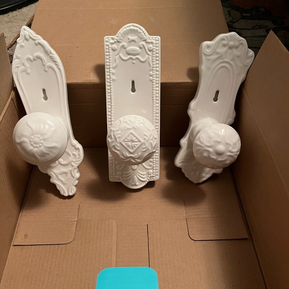 Set of three ceramic hooks that look like doorknobs.